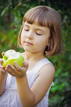 Child with an apple. Selective focus. nature food.