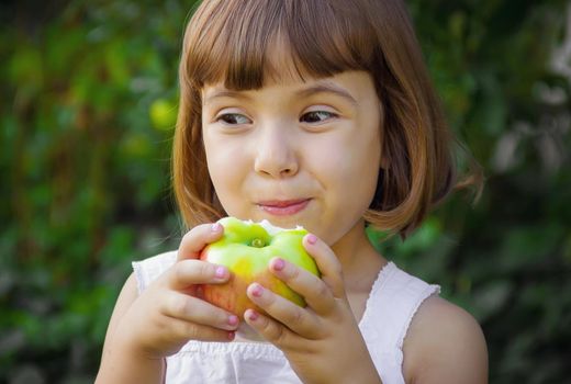 Child with an apple. Selective focus. nature food.