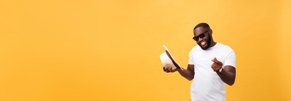 Young black man top dancing isolated on a yellow background