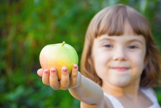 Child with an apple. Selective focus. nature food.