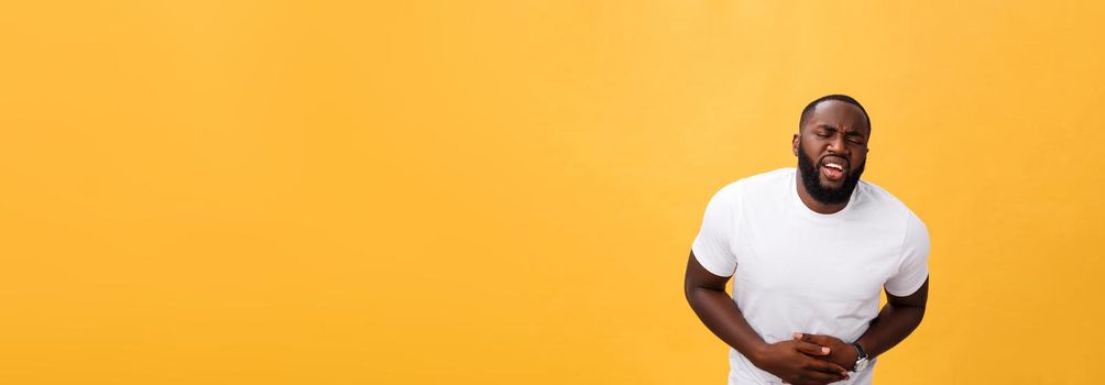 Young african american man wearing white t-shirt with hand on stomach because nausea, painful disease feeling unwell. Ache concept.