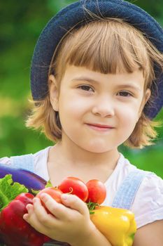 Child and vegetables on the farm. Selective focus. nature.