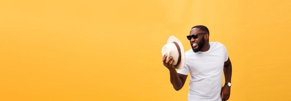 Young black man top dancing isolated on a yellow background