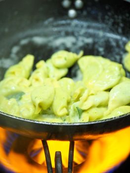 chef blending green ricotta cheese spinach filling tortellini
