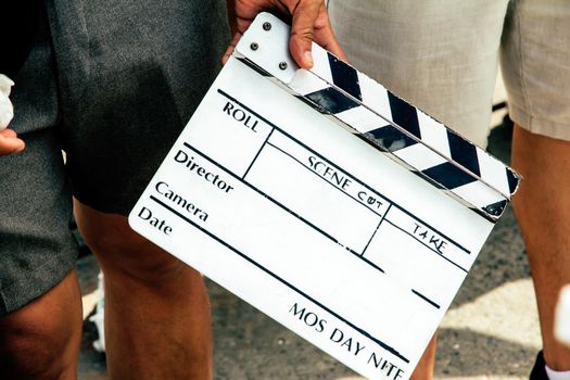 close up image of film production crew holding Film Slate on set