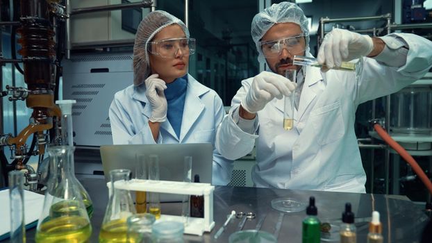 Two scientist in professional uniform working in laboratory for chemical and biomedical experiment