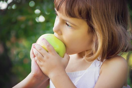 Child with an apple. Selective focus. nature food.