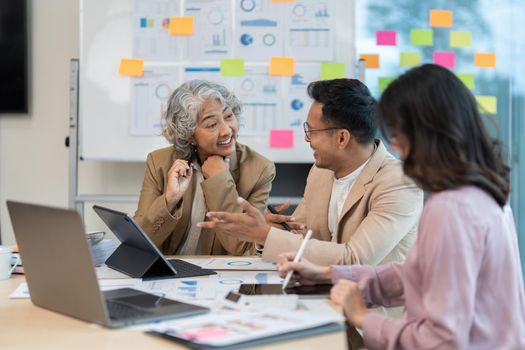 Group of Business people discuss a marketing strategy to improve the quality of their sales in the future at meeting room.