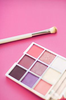 Cosmetic branding, mua and girly concept - Eyeshadow palette and make-up brush on rose background, eye shadows cosmetics product for luxury beauty brand promotion and holiday fashion blog design