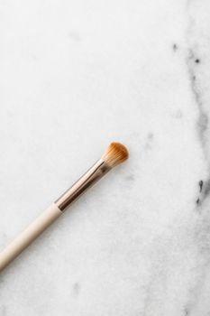 Cosmetic branding, blog and girly concept - Make-up brush for foundation base face contouring on marble background, mua cosmetics as glamour makeup artist product for luxury beauty brand art design