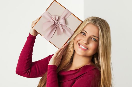 Holiday present for birthday, baby shower, wedding or luxury beauty box subscription delivery, happy woman holding a wrapped pink gift on white background