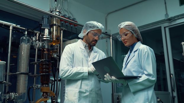 Two scientist in professional uniform working in laboratory for chemical and biomedical experiment