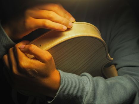 woman violinmaker at work with the fiddle