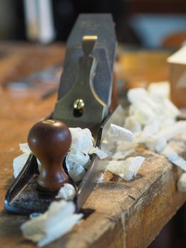 Close up of professional master artisan luthier painstaking detailed work on wood violin in a workshop.