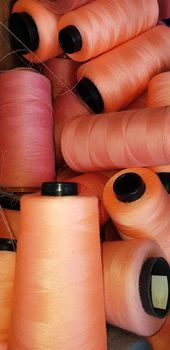 Colorful yarn on spool, yarn on tube, cotton, wool, linen thread orange