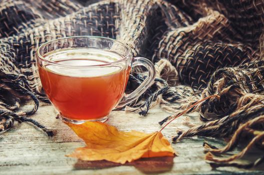 A cup of tea and a cozy autumn background. Selective focus. food.