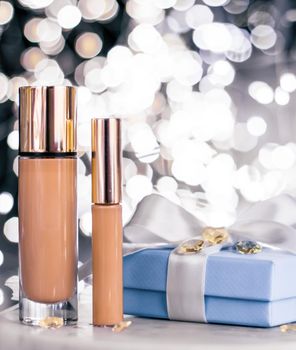 Cosmetic branding, Christmas glitter and girly blog concept - Holiday make-up foundation base, concealer and blue gift box, luxury cosmetics present and blank label products for beauty brand design