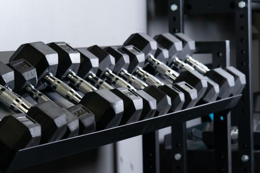 Dumbbell home wall blurry gym set storage rig sport, for accessories gear from black for exercise active, power hard. Lifting