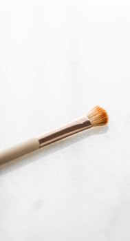 Cosmetic branding, blog and girly concept - Make-up brush for foundation base face contouring on marble background, mua cosmetics as glamour makeup artist product for luxury beauty brand art design