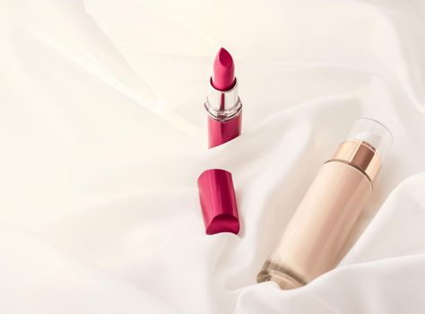 Cosmetic branding, glamour and skincare concept - Beige tonal cream bottle make-up fluid foundation base and red lipstick on silk background, cosmetics products as luxury beauty brand holiday design