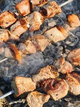 Texture or background.Pork kebab on skewers over coals close-up
