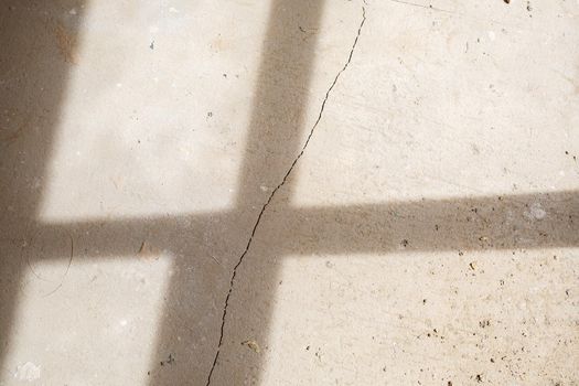 Cracks in the concrete cement screed on the floor after repair. The concrete surface texture is covered with web cracks. Gray stone background