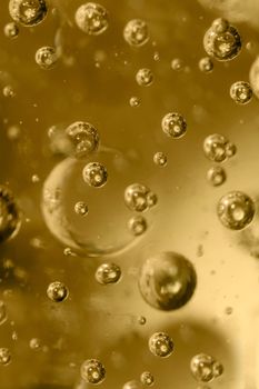 Large and small bubbles in a plastic form of golden color close-up.Texture or background.Selective focus.