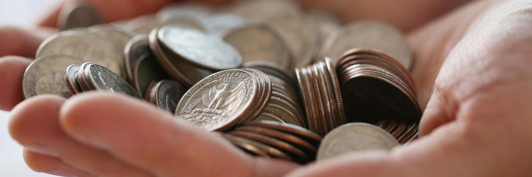 Close-up of pile of coins in businessman hands, earned money, work hard. Future needs, loan, credit spend on vacation, savings for future. Finance concept