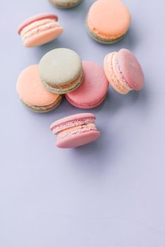 Pastry, bakery and branding concept - French macaroons on blue background, parisian chic cafe dessert, sweet food and cake macaron for luxury confectionery brand, holiday backdrop design