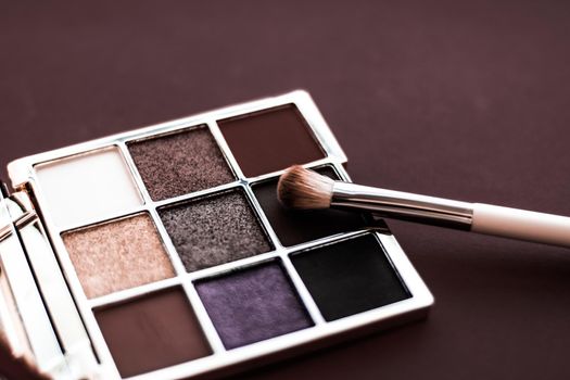 Cosmetic branding, mua and girly concept - Eyeshadow palette and make-up brush on chocolate background, eye shadows cosmetics product for luxury beauty brand promotion and holiday fashion blog design
