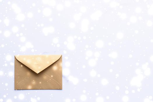 Greetings, postal service and online newsletter concept - Winter holiday blank paper envelopes on marble with shiny snow flatlay background, love letter or Christmas mail card design