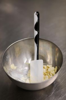 chef making for icing a lilac drip cake in the professional kitchen lab