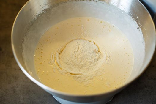 Beating cream for a sweet dessert in a food processor. Cream nozzle