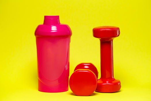 red dumbbells, pink shaker, colored background, sports, energy drink, gym equipment