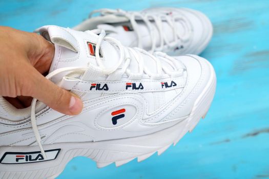 Tyumen, Russia-August 12, 2022: Fila shoe, model disruptor 2 white popular. Fila logo is one of the world largest sportswear manufacturing companies.