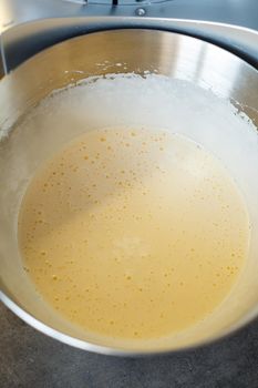 Beating cream for a sweet dessert in a food processor. Cream nozzle