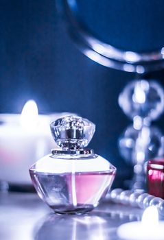 Perfumery, cosmetics branding and luxe concept - Perfume bottle and vintage fragrance on glamour vanity table at night, pearls jewellery and eau de parfum as holiday gift, luxury beauty brand present