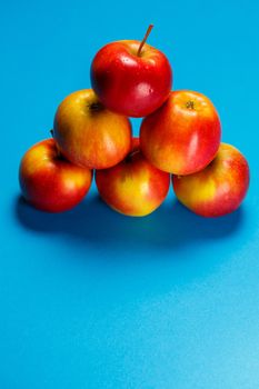 red-yellow juicy apples on a blue background. Healthy Nutrition and Vitamins