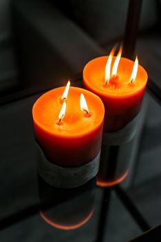 red candle on a gray concrete base.