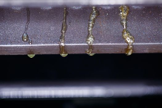 drops of fat flowing from the electric grill during meat cooking