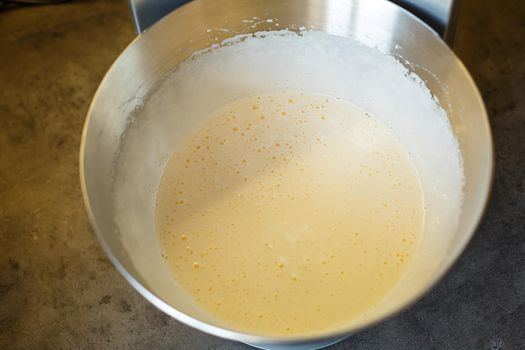 Beating cream for a sweet dessert in a food processor. Cream nozzle