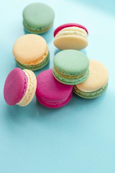 Pastry, bakery and branding concept - French macaroons on blue background, parisian chic cafe dessert, sweet food and cake macaron for luxury confectionery brand, holiday backdrop design