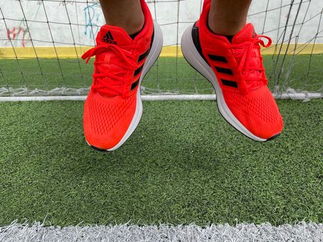 Tyumen, Russia-August 13, 2022: New Adidas Running Shoes, orange coral color, eq21 run.