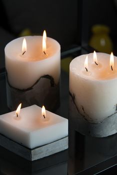 white candle on a concrete base.