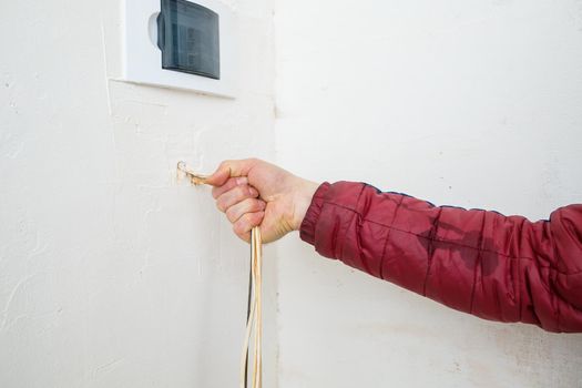 Electricity installation. During repair. open the wires. Sticking out isolated on a white wall. Professional installation electrically