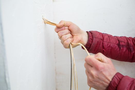 Electricity installation. During repair. open the wires. Sticking out isolated on a white wall. Professional installation electrically