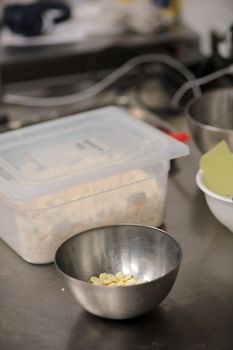 chef making for icing a lilac drip cake in the professional kitchen lab