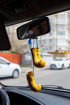 little boxing gloves on the rearview mirror in a car