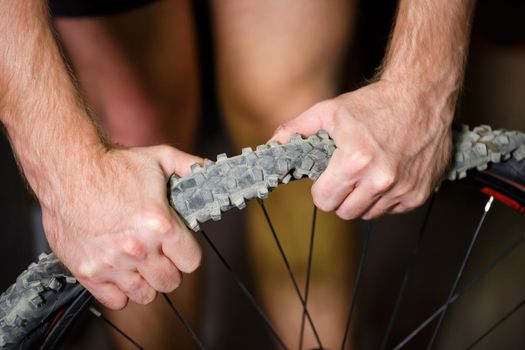 A man changes the camera on a bicycle wheel. Spike Bike Chamber