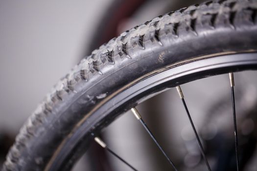 Black rubber tire with spikes for a bicycle wheel. Bike accessories
